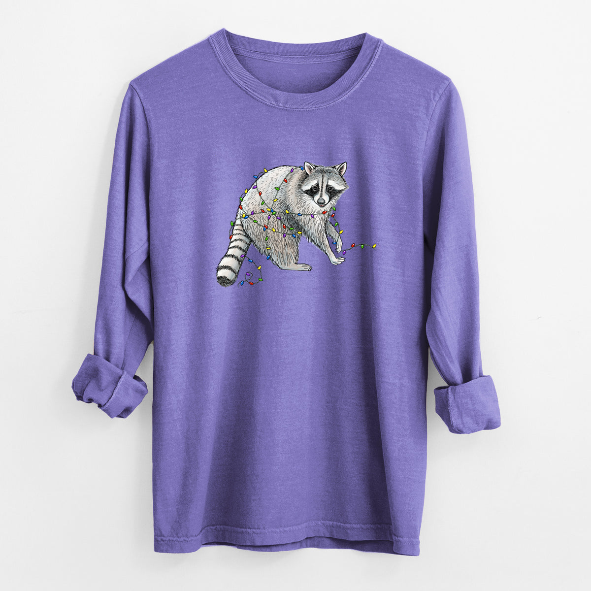 Violet purple Comfort Colors long sleeve shirt laid flat with the cuffs rolled, printed with a black ink raccoon tangled in a string of colorful holiday lights.