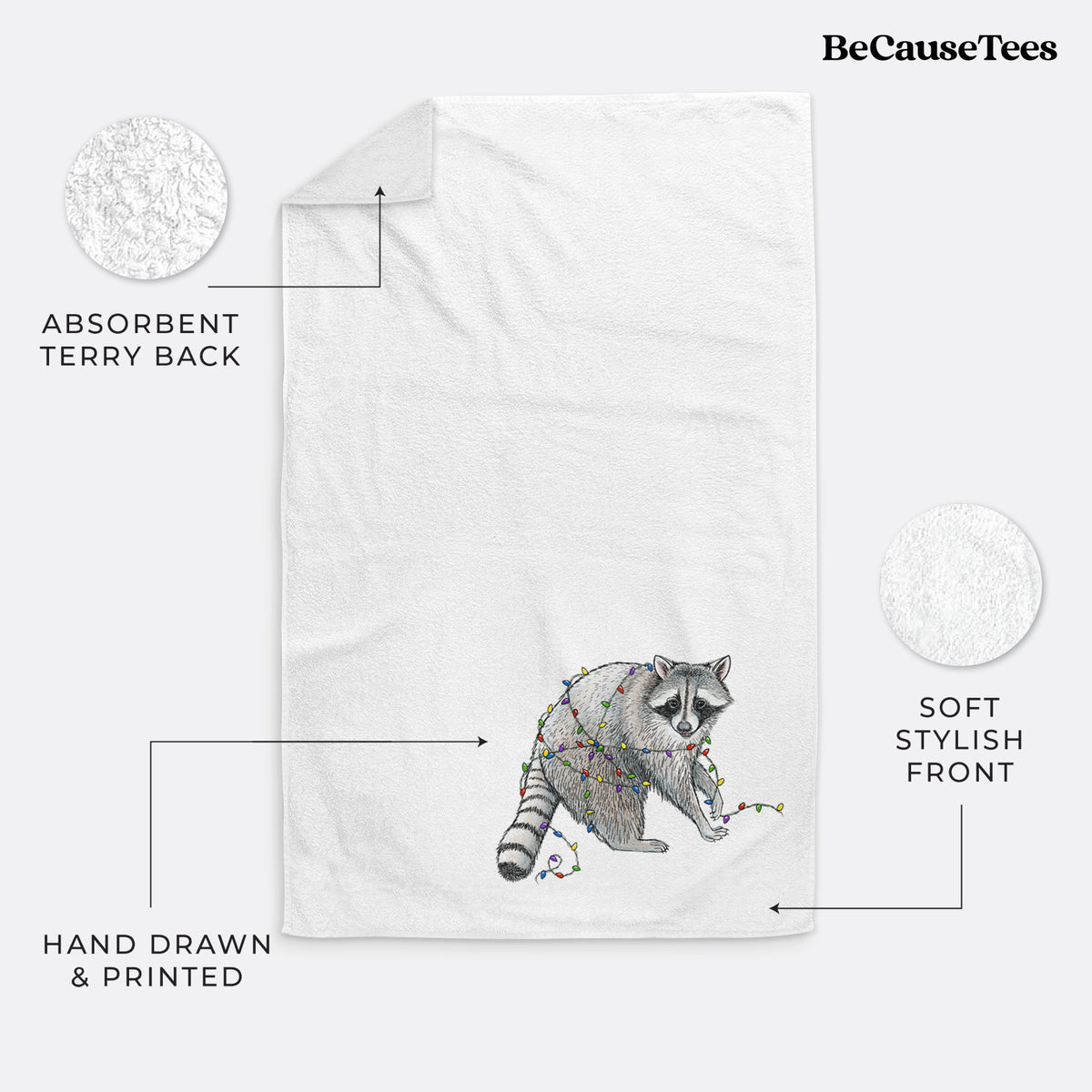 White hand towel printed with a black ink raccoon tangled in a string of colorful holiday lights.