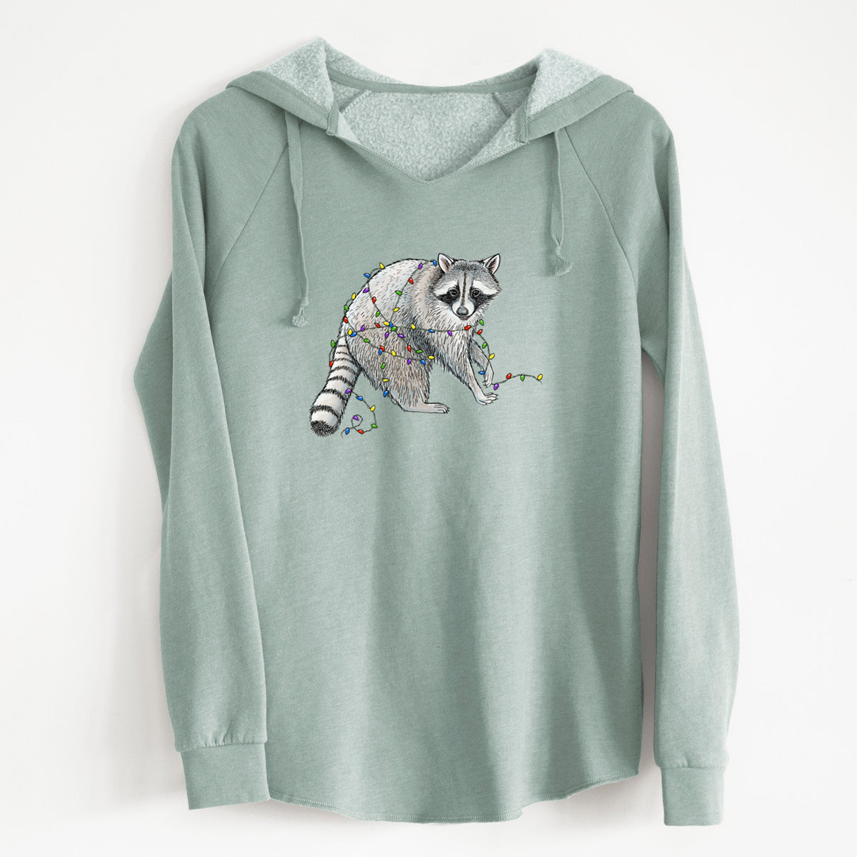 Sage green women's Cali Wave hooded sweatshirt laid flat, printed with a black ink raccoon tangled in a string of colorful holiday lights.