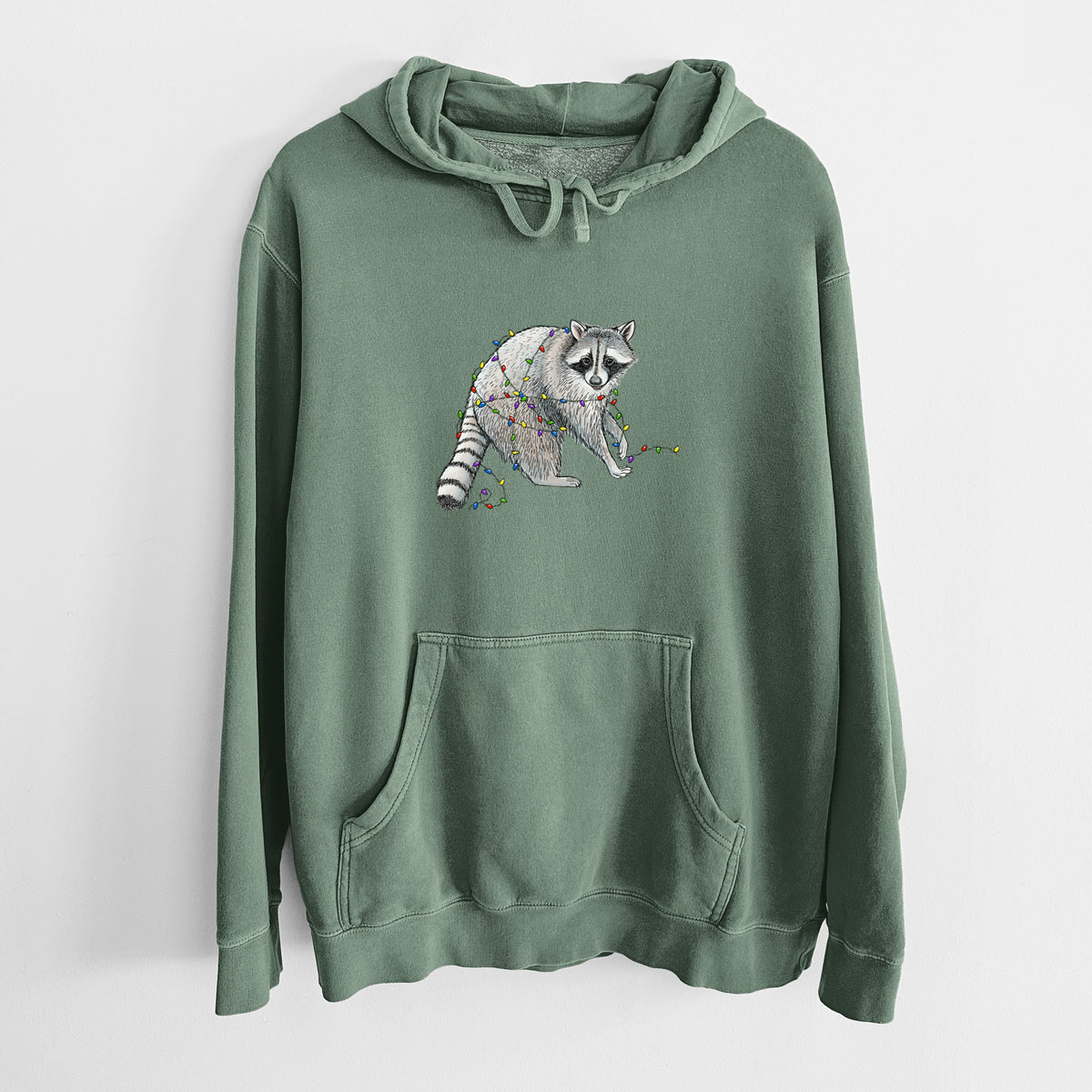 Alpine green pigment dyed hoodie laid flat, printed with a black ink raccoon tangled in a string of colorful holiday lights.