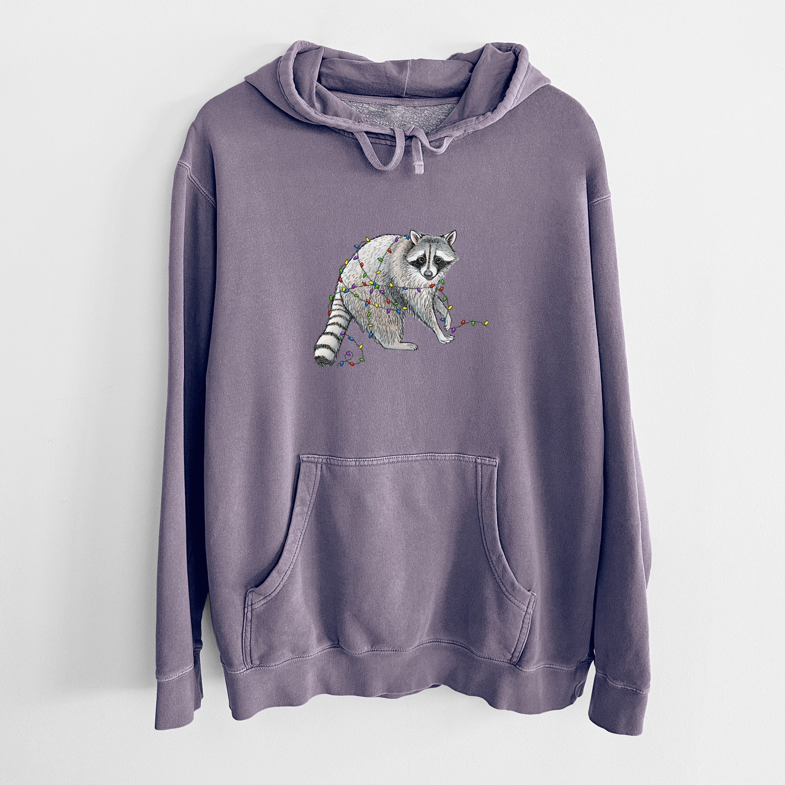 Plum purple pigment dyed hoodie laid flat, printed with a black ink raccoon tangled in a string of colorful holiday lights.