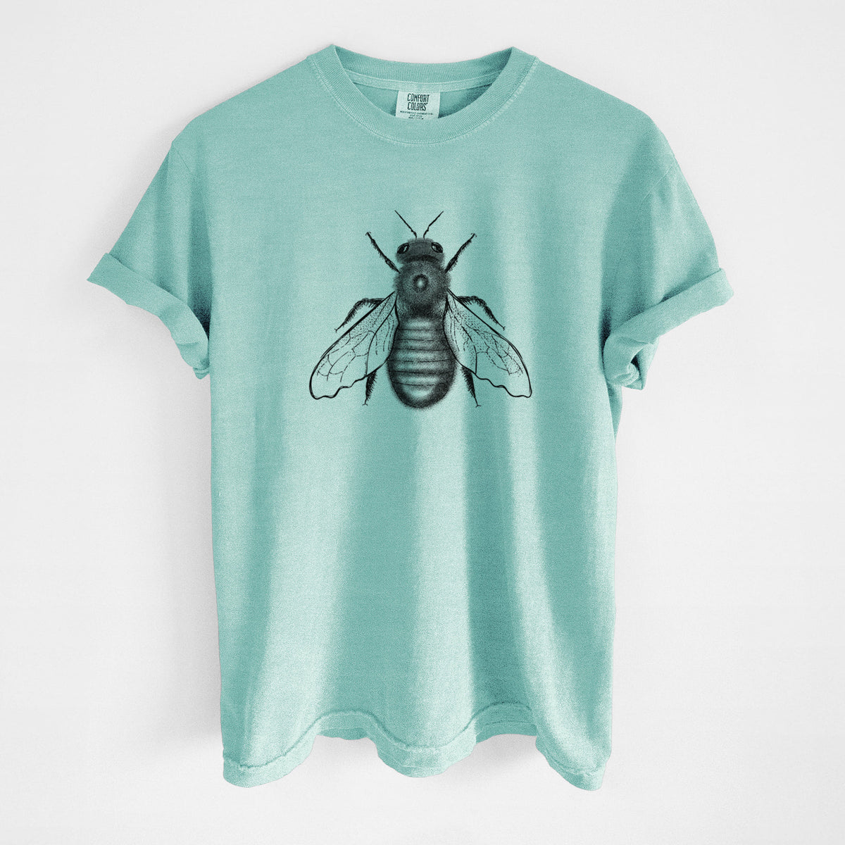 Chalky mint Comfort Colors t-shirt laid flat, printed with a detailed black ink illustration of an eastern carpenter bee with its wings spread, seen from above.