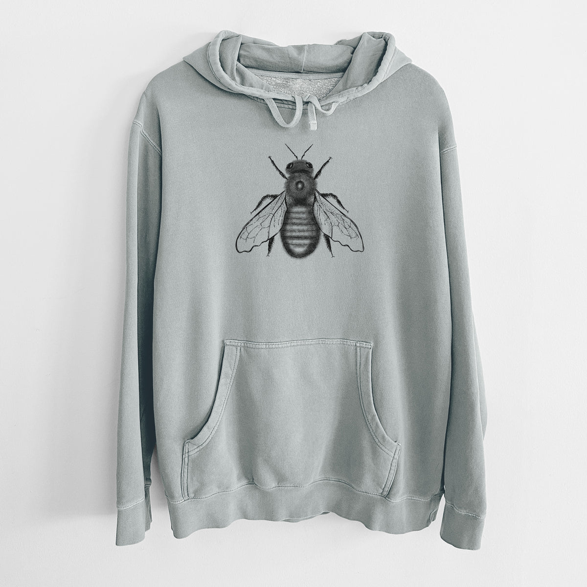 Sage green pigment dyed hoodie laid flat, printed with a detailed black ink illustration of an eastern carpenter bee with its wings spread, seen from above.