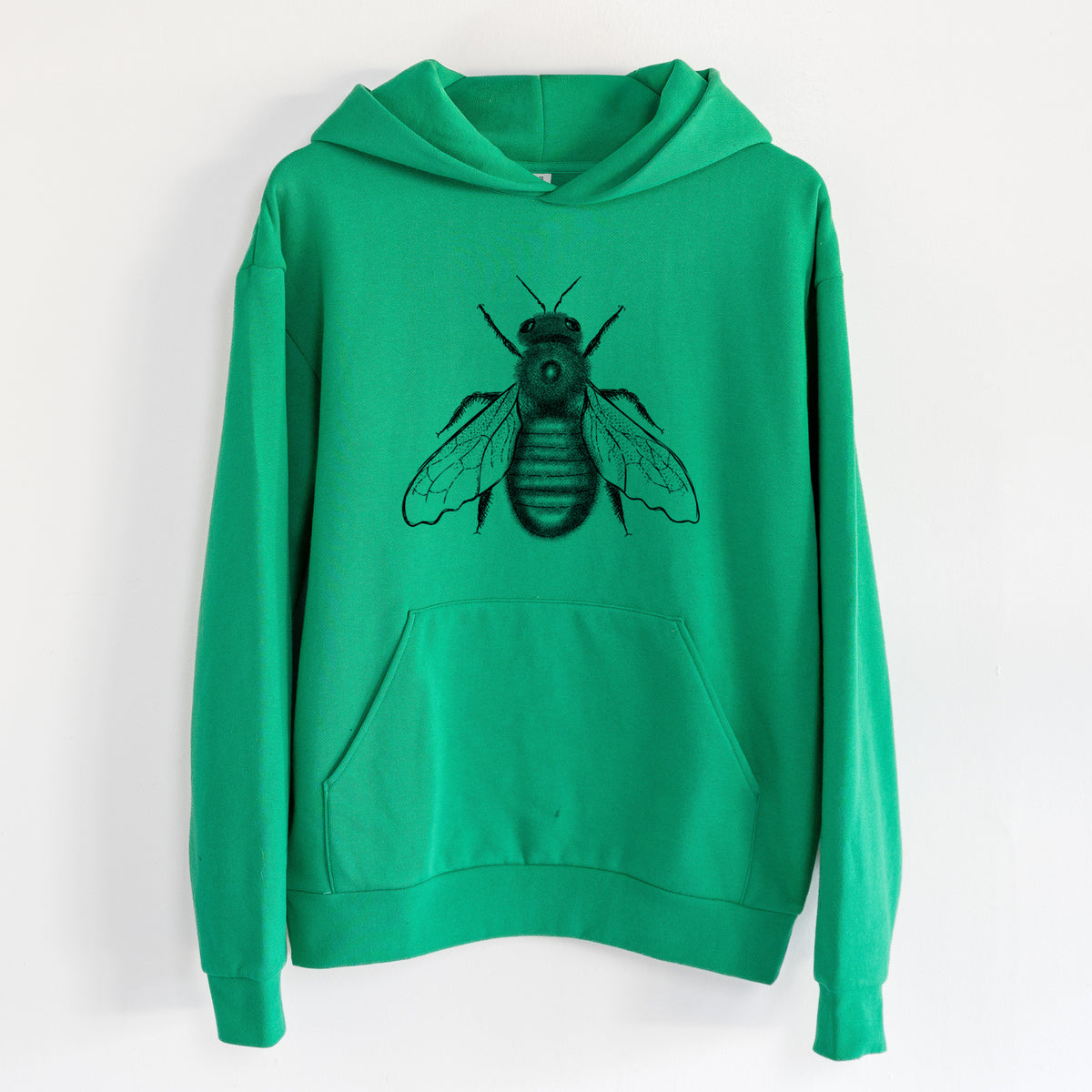 Xylocopa Virginica - Carpenter Bee - Statement Midweight Hoodie in Kelly Green, hanging on a white wall, with a front kangaroo pocket and no drawcords.