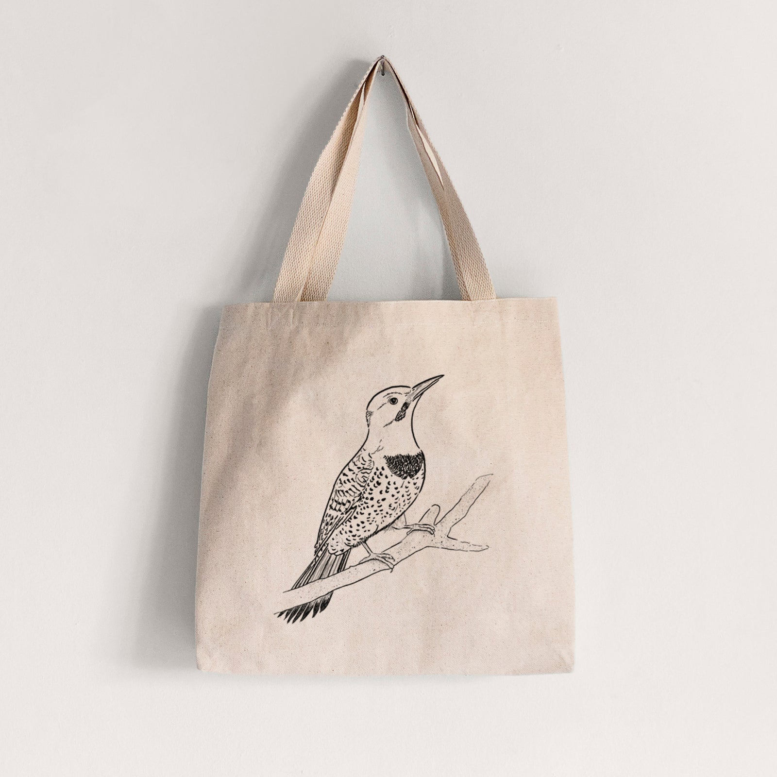 Natural canvas tote bag printed with a detailed black ink illustration of a yellow-shafted northern flicker perched on a branch.