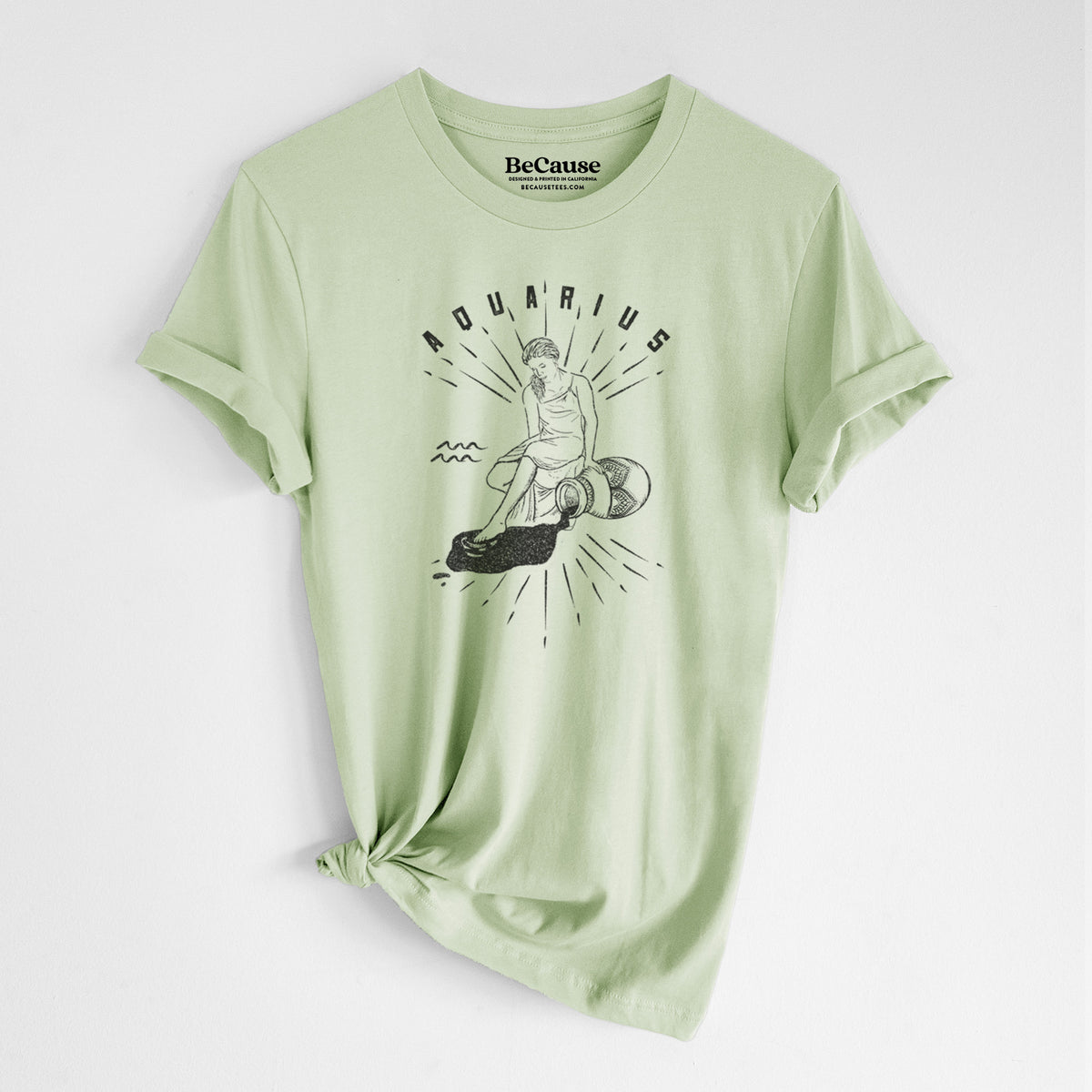 Spring green lightweight cotton t-shirt laid flat with the sleeves rolled, printed with a black ink figure pouring water with the word Aquarius, for the Aquarius zodiac sign.