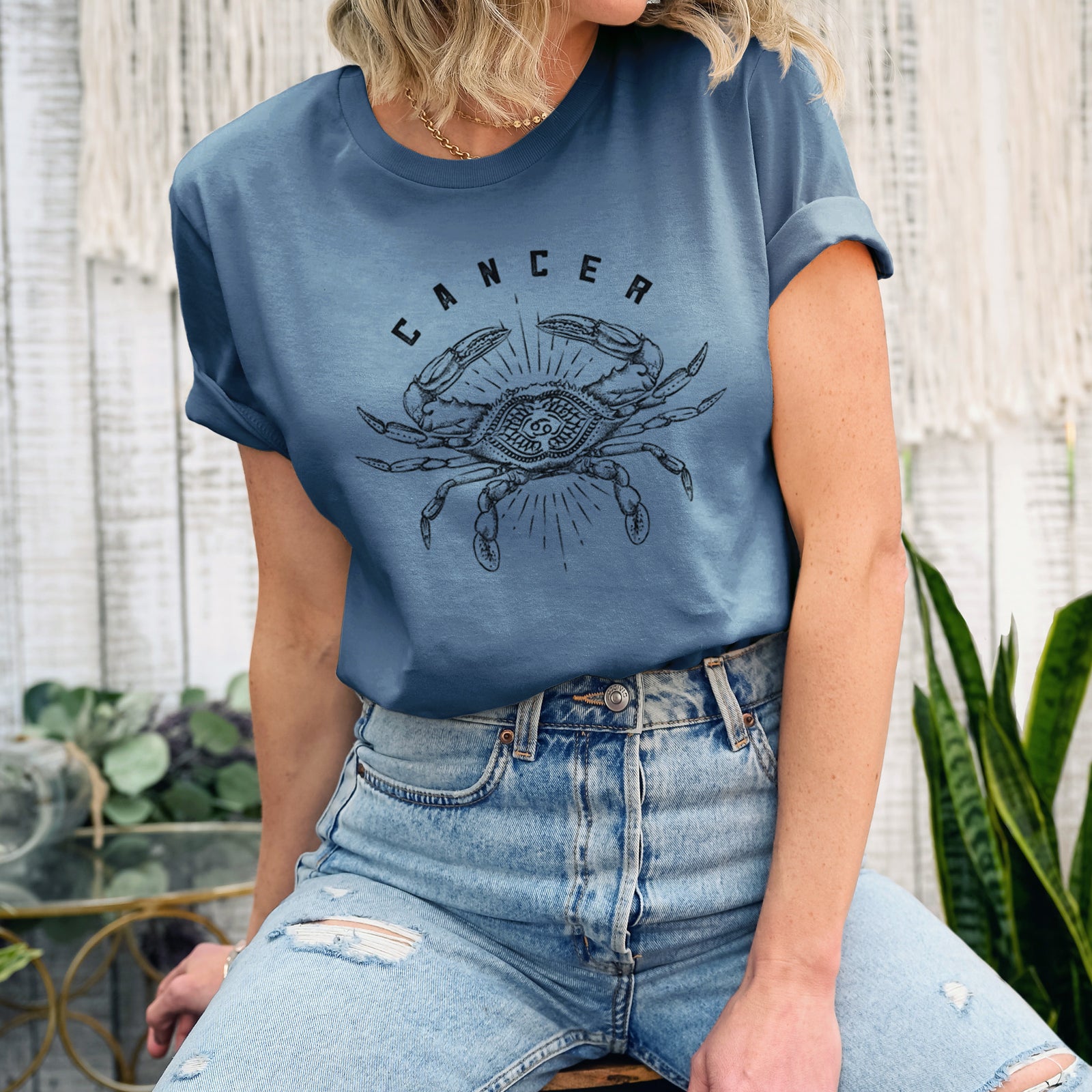 Autumn lightweight cotton t-shirt laid flat, printed with a black ink crab with the word Cancer, for the Cancer zodiac sign.