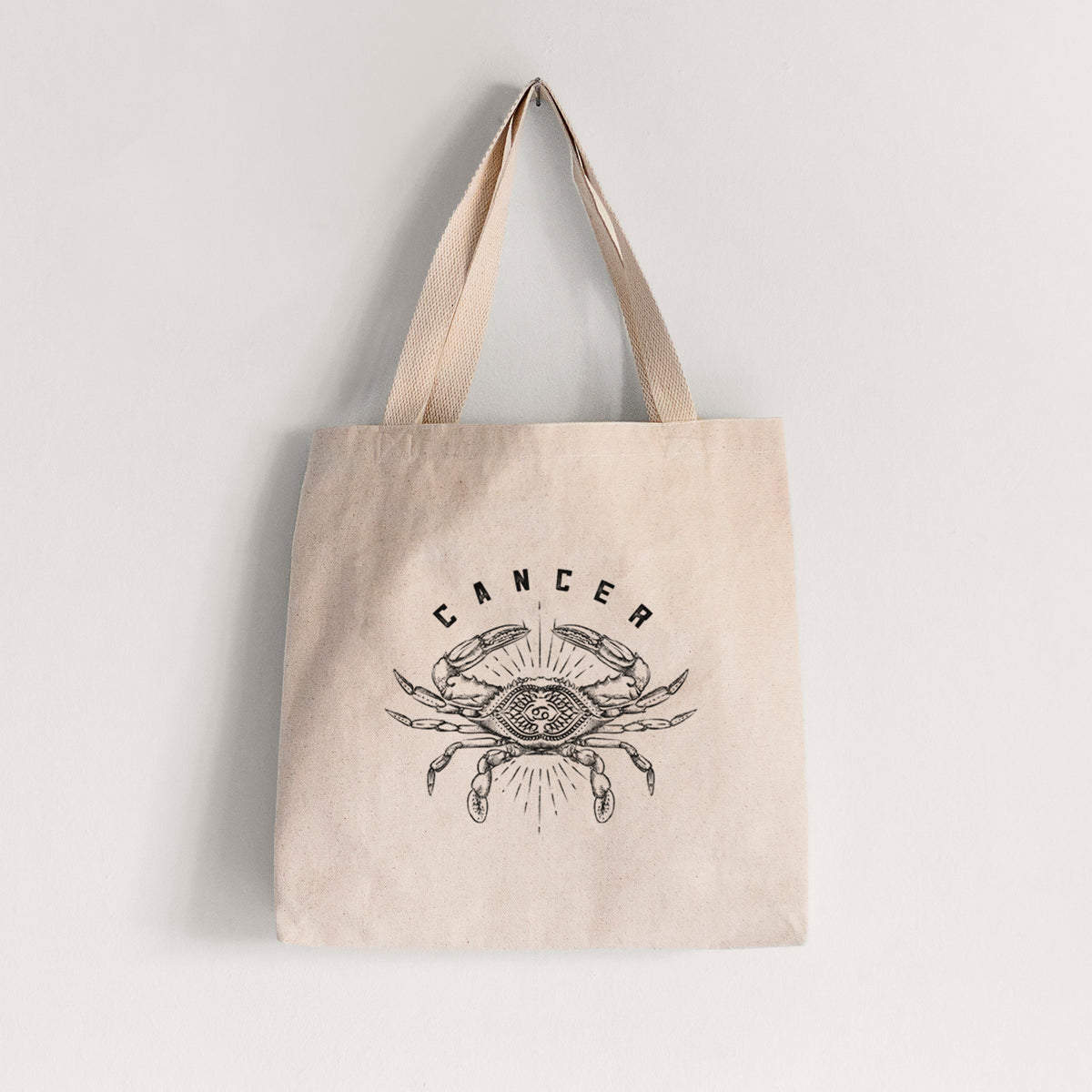 Natural canvas tote bag printed with a black ink crab with the word Cancer, for the Cancer zodiac sign.