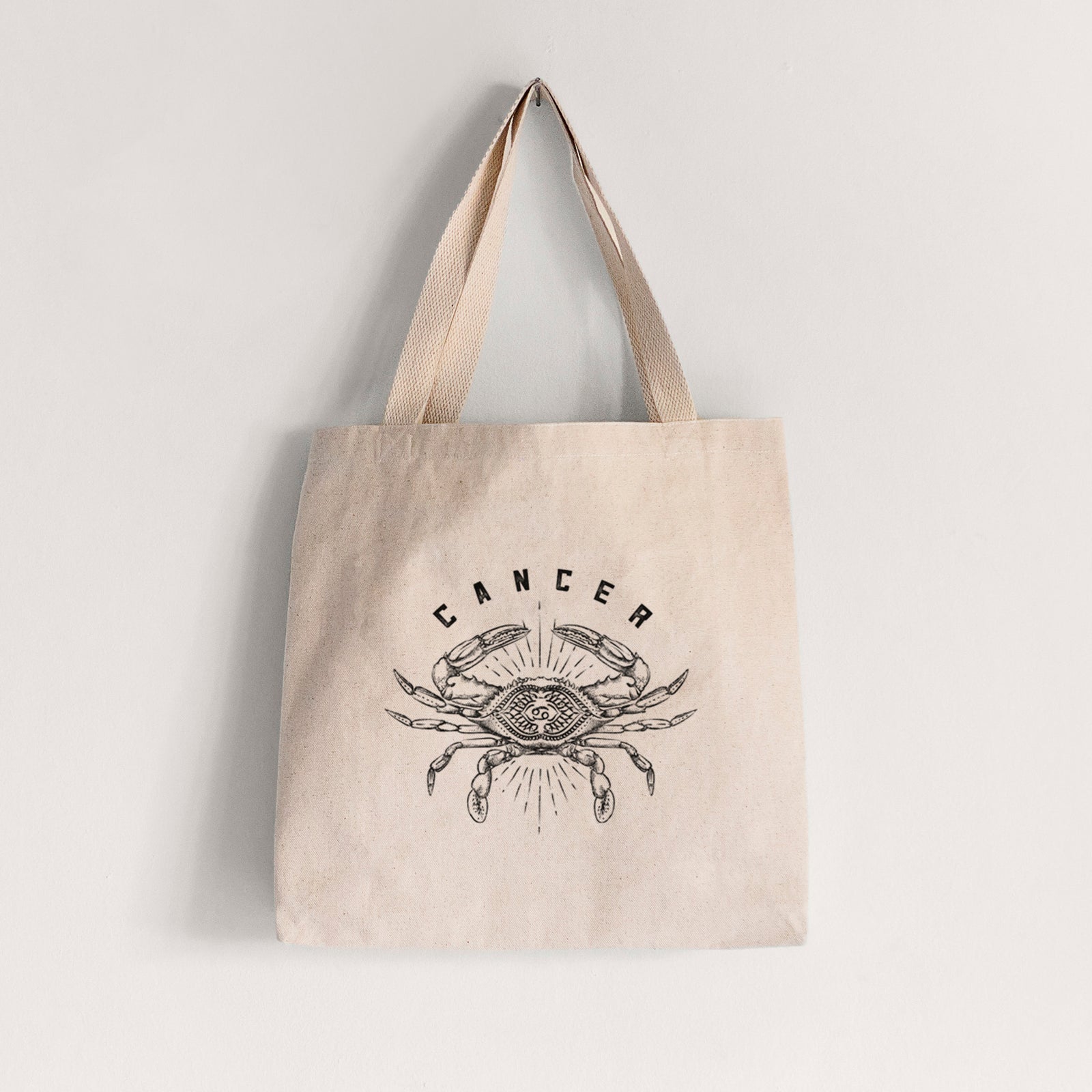 Natural canvas tote bag printed with a black ink crab with the word Cancer, for the Cancer zodiac sign.