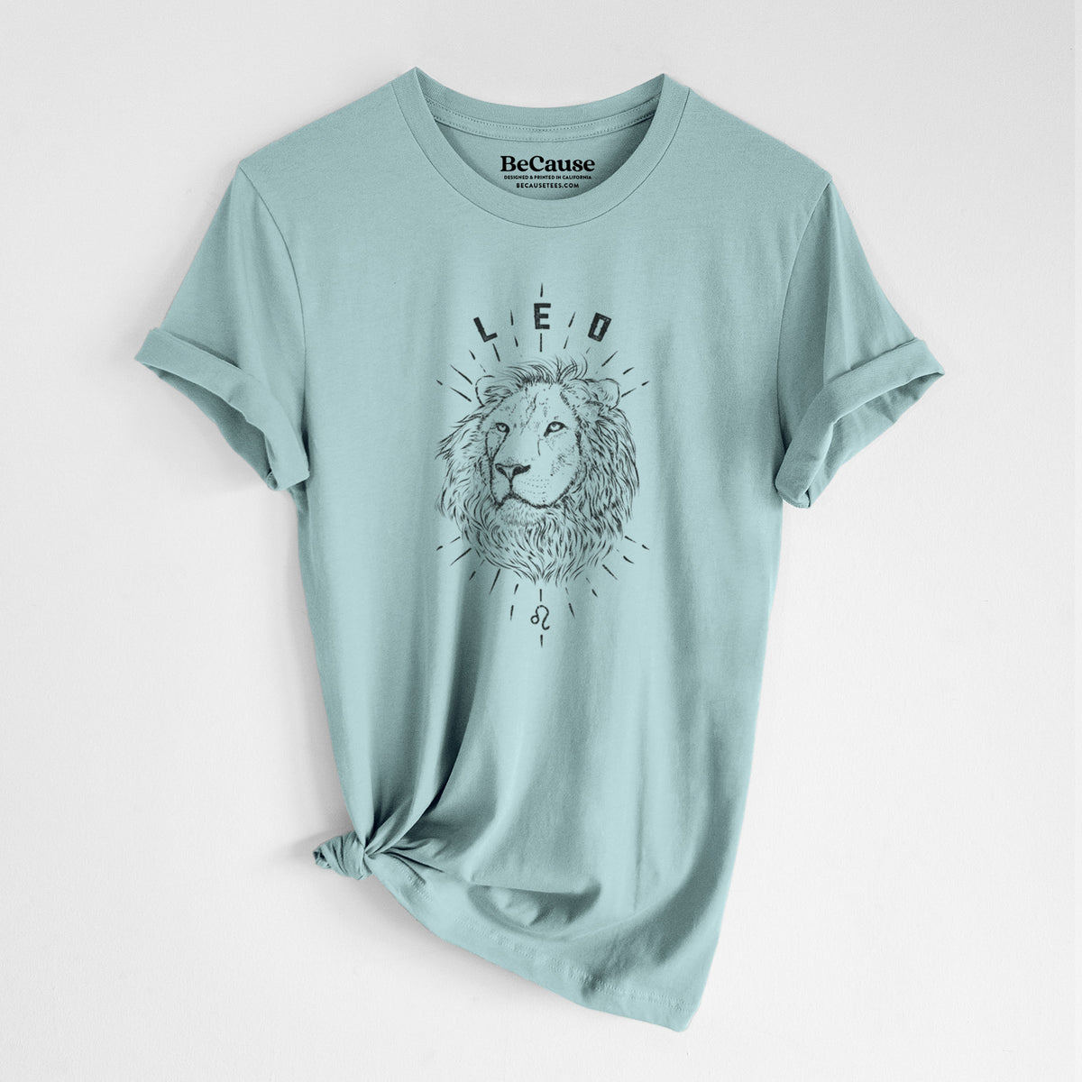 Dusty blue lightweight cotton t-shirt laid flat with the sleeves rolled, printed with a black ink lion's head with the word Leo, for the Leo zodiac sign.