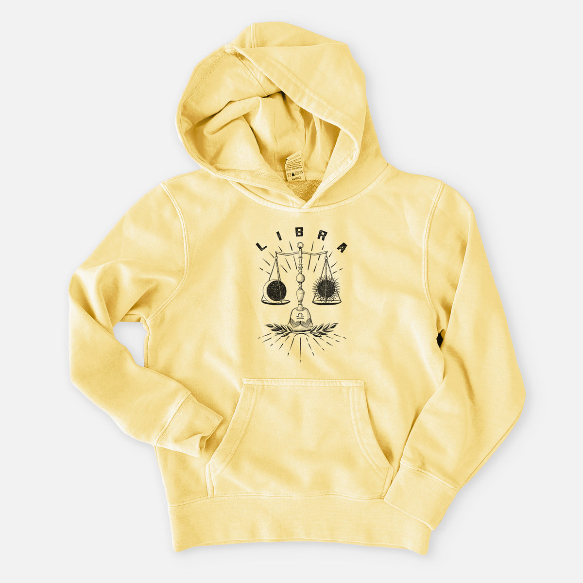 Pigment yellow youth pigment dyed hoodie laid flat, printed with a black ink set of balance scales with the word Libra, for the Libra zodiac sign.