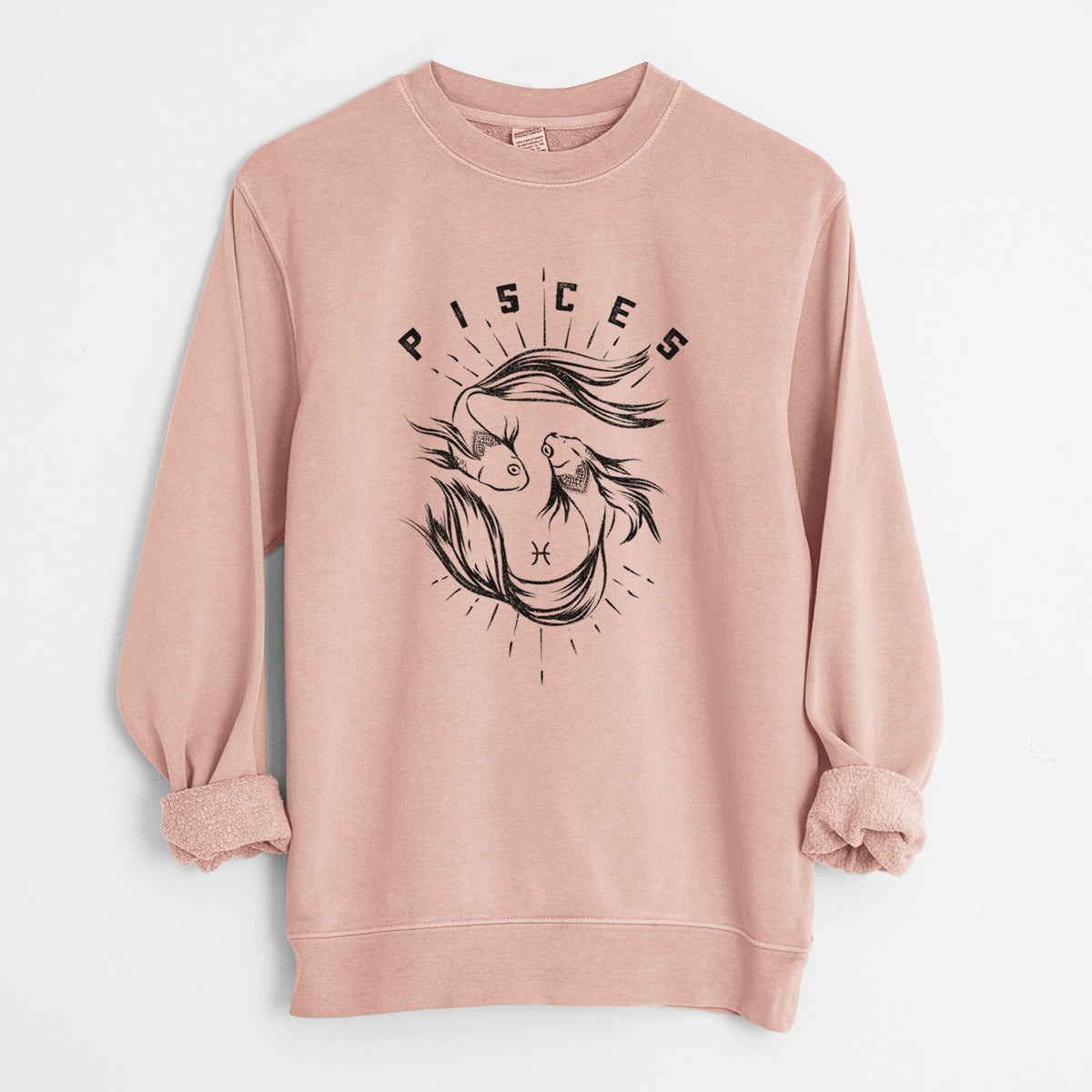 Dusty pink pigment dyed crewneck sweatshirt laid flat with the sleeves rolled, printed with two black ink fish swimming in a circle with the word Pisces, for the Pisces zodiac sign.