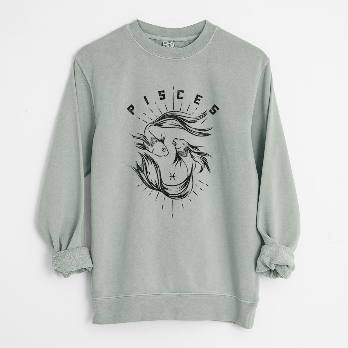 Sage green pigment dyed crewneck sweatshirt laid flat with the sleeves rolled, printed with two black ink fish swimming in a circle with the word Pisces, for the Pisces zodiac sign.