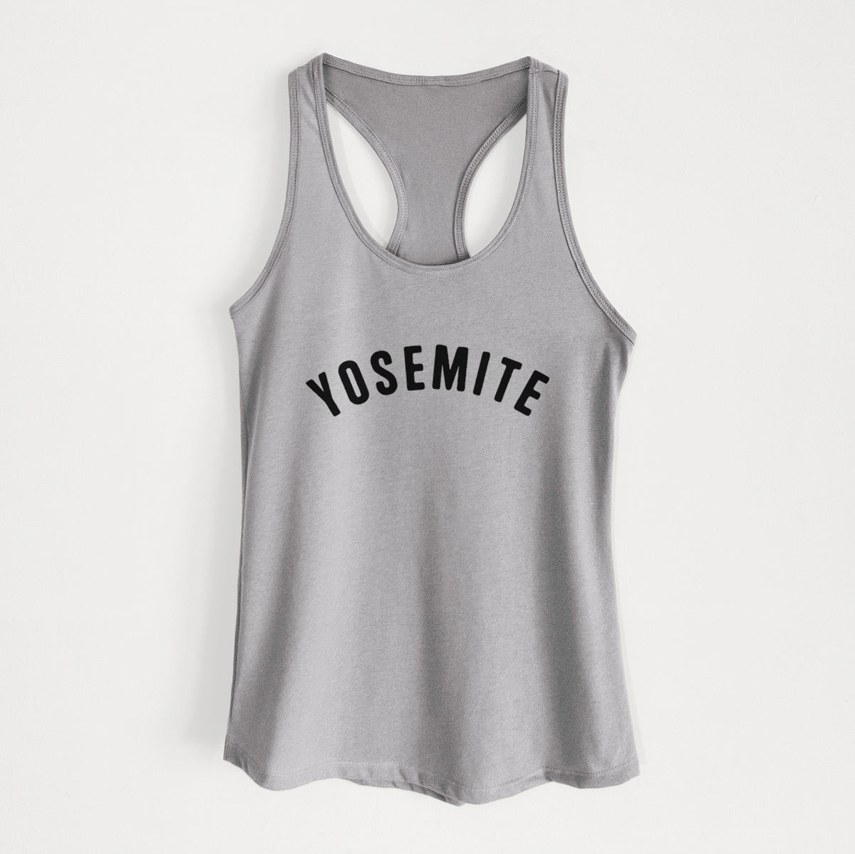 Heather grey women's racerback tank top laid flat, printed with the word Yosemite in bold black letters arched across the chest.