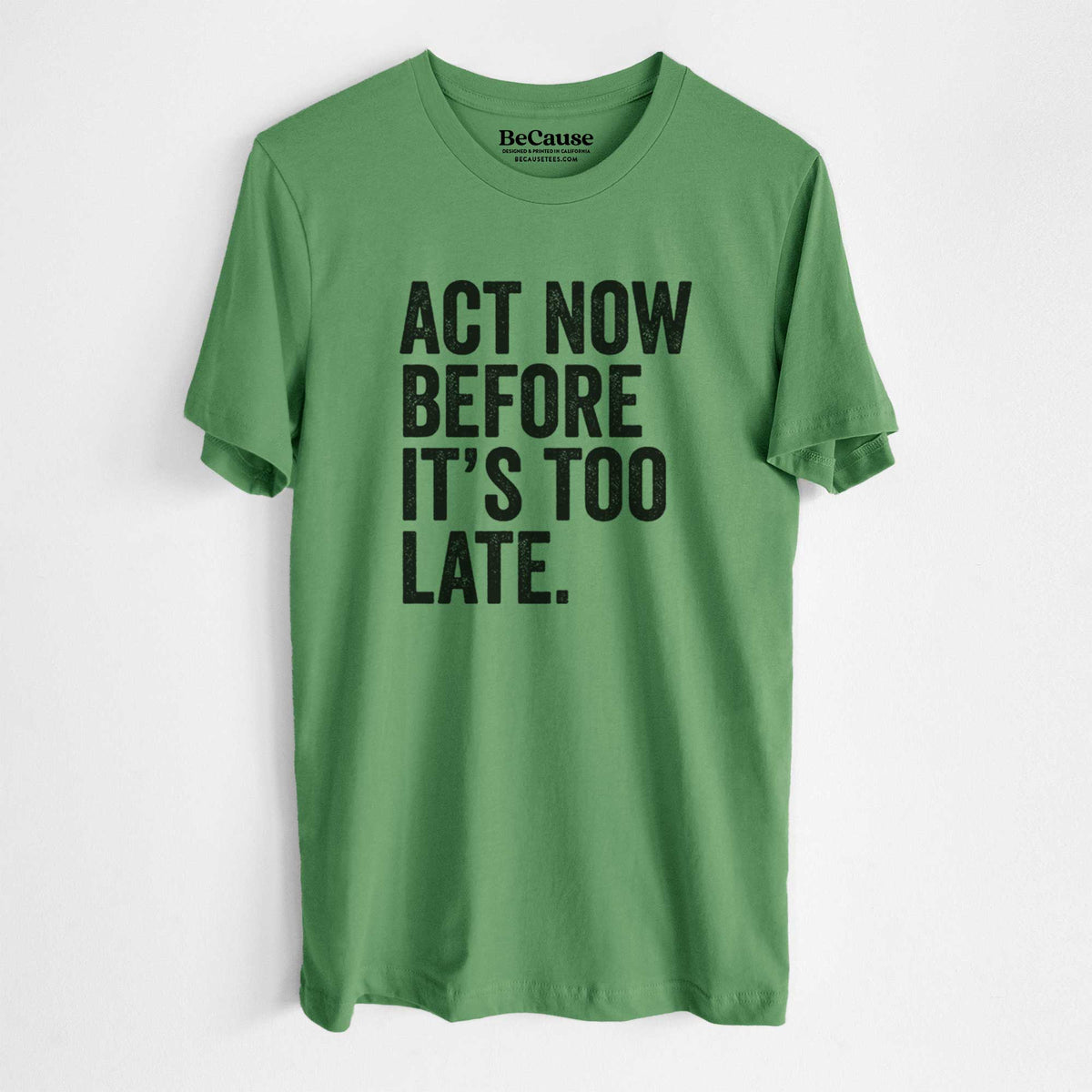 Leaf green lightweight cotton t-shirt laid flat, printed with bold black words reading Act Now Before It's Too Late.