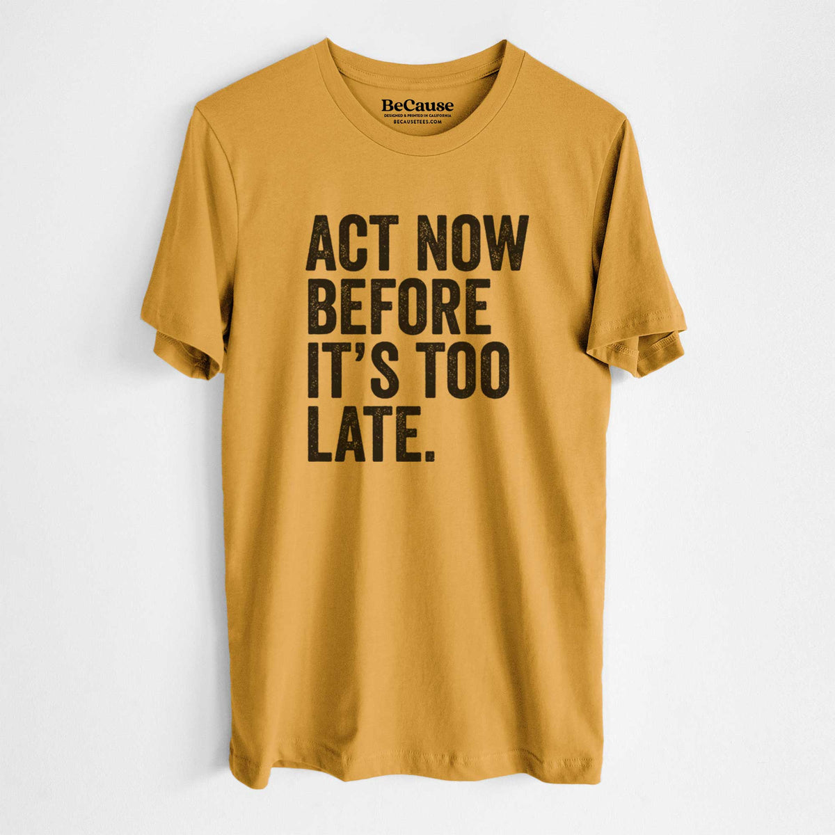 Mustard yellow lightweight cotton t-shirt laid flat, printed with bold black words reading Act Now Before It's Too Late.