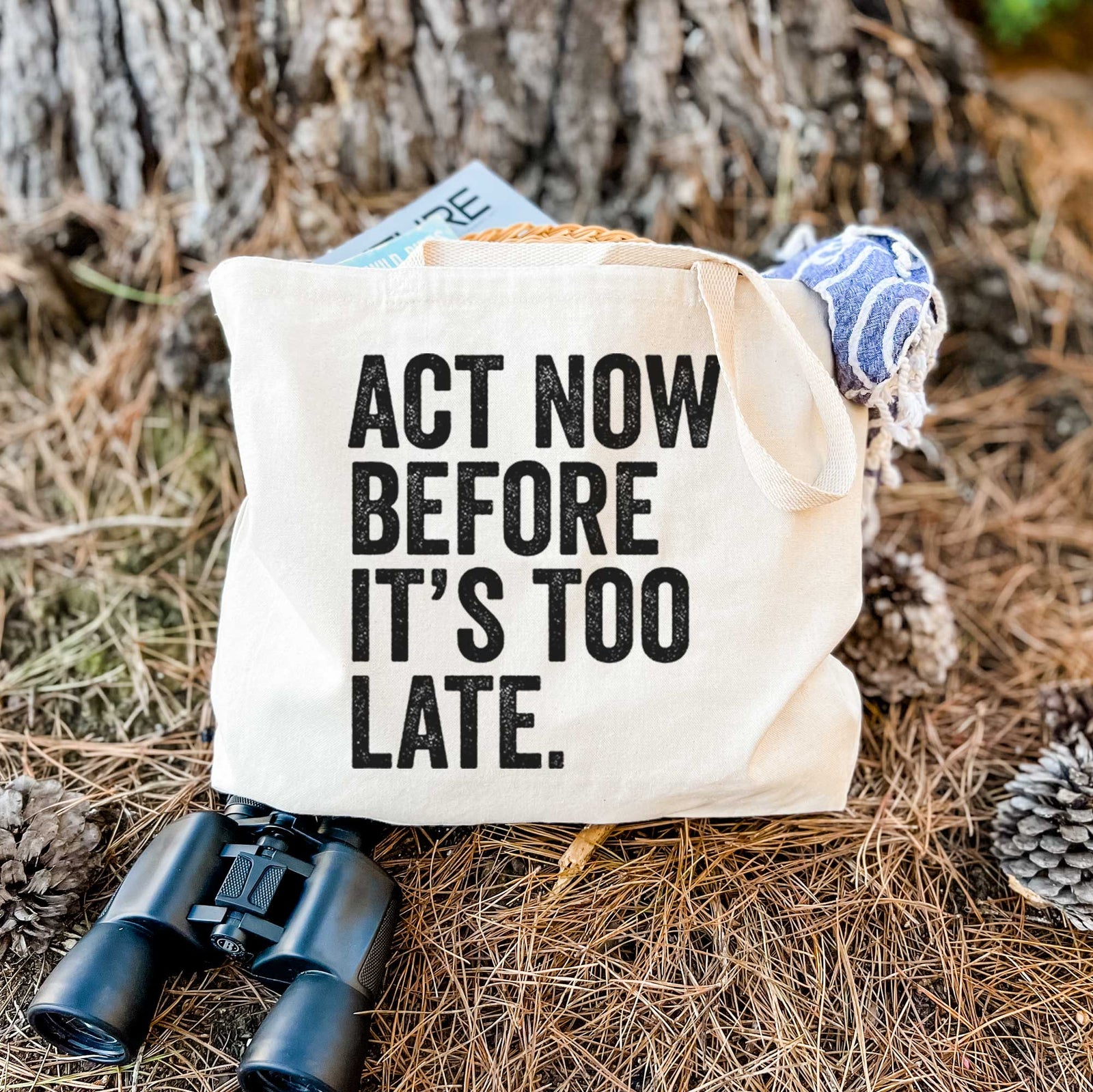 Natural canvas tote bag printed with bold black words reading Act Now Before It's Too Late.