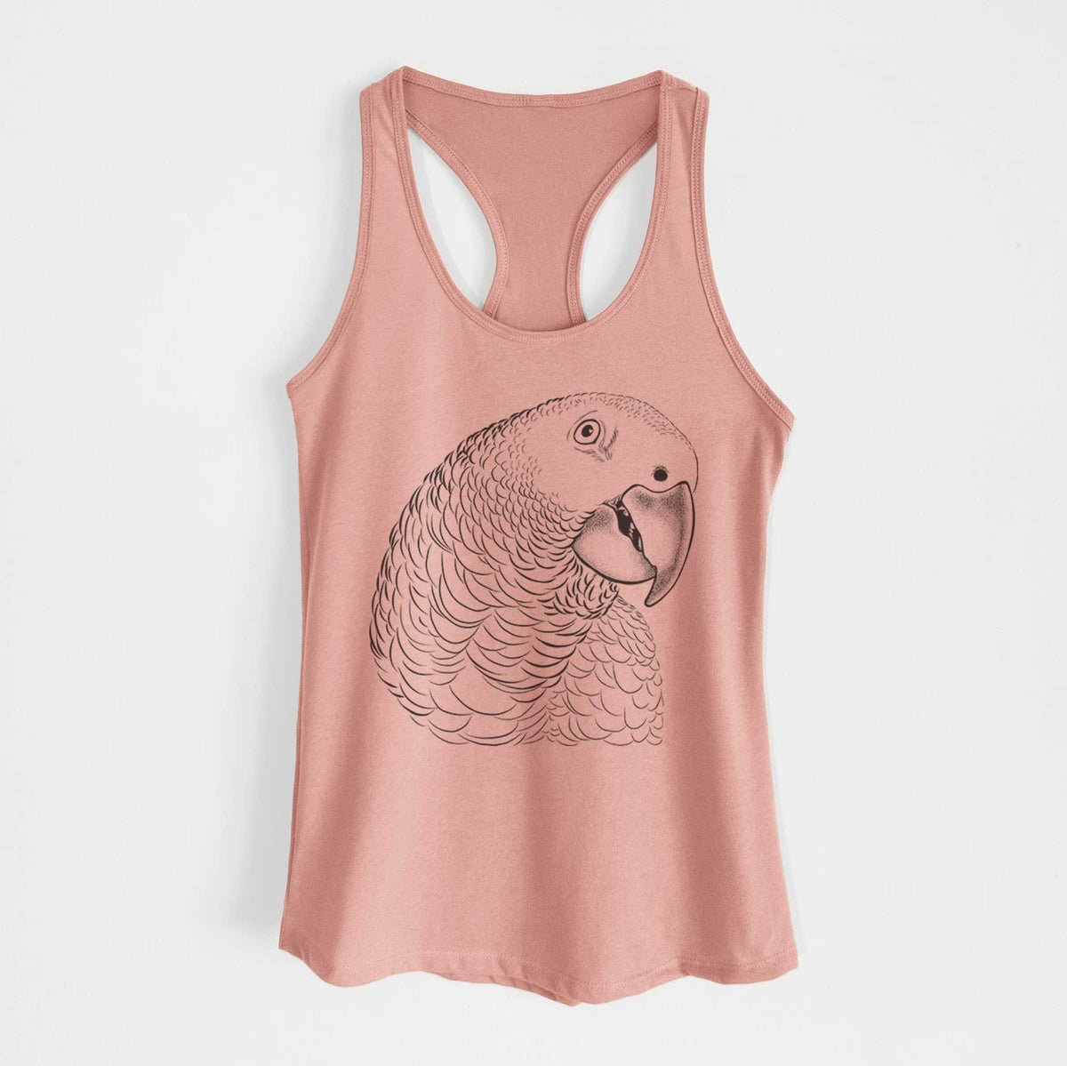 Desert pink women's racerback tank top laid flat, printed with a detailed black ink portrait of an African grey parrot's head.