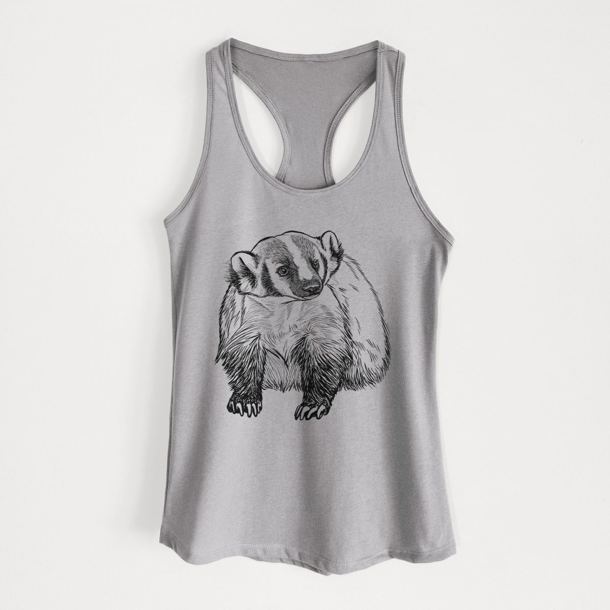 Heather grey women's racerback tank top laid flat, printed with a detailed black ink illustration of an American badger facing forward.