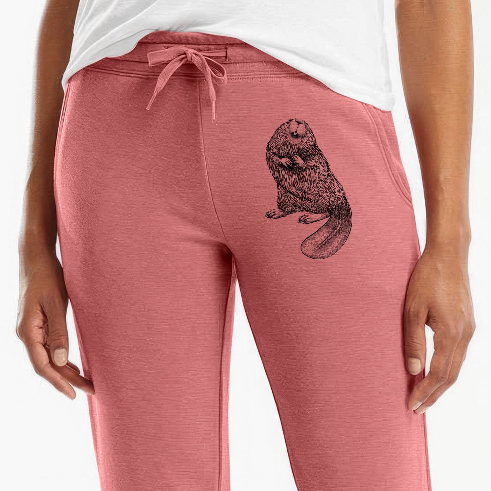 Front of dusty rose Cali Wave sweatpants, printed with a detailed black ink illustration of an American beaver sitting upright with its flat tail on the leg.