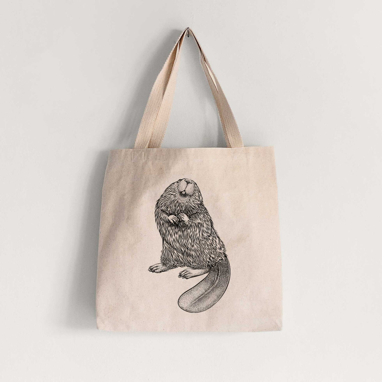 Natural canvas tote bag printed with a detailed black ink illustration of an American beaver sitting upright with its flat tail.