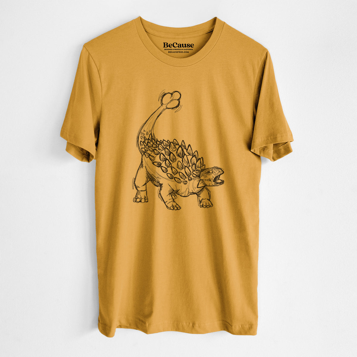Mustard yellow lightweight cotton t-shirt laid flat, printed with a black ink illustration of an Ankylosaurus with its club tail raised.