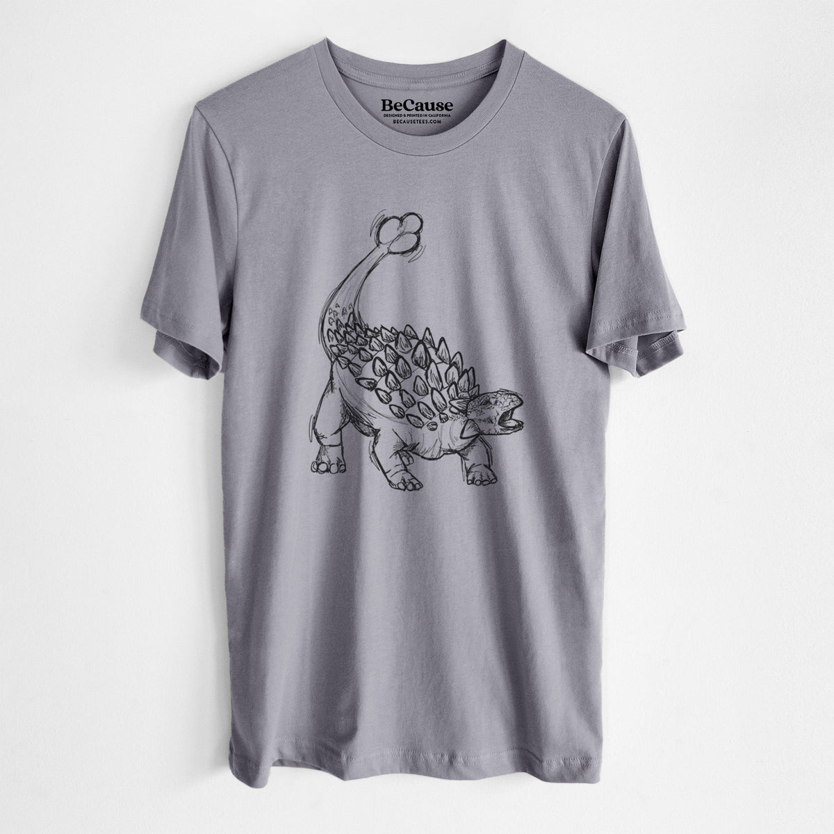 Storm grey lightweight cotton t-shirt laid flat, printed with a black ink illustration of an Ankylosaurus with its club tail raised.