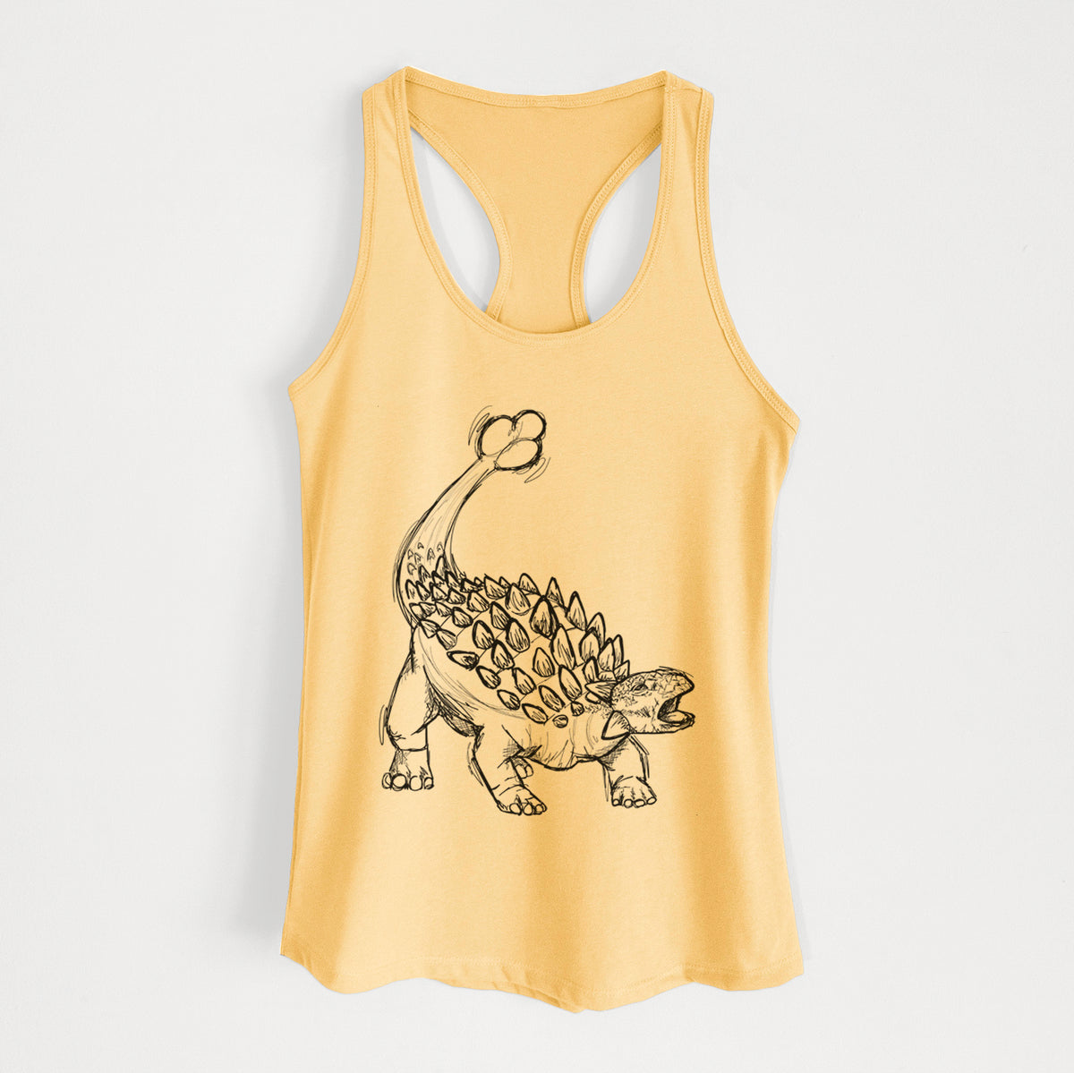 Banana cream women's racerback tank top laid flat, printed with a black ink illustration of an Ankylosaurus with its club tail raised.
