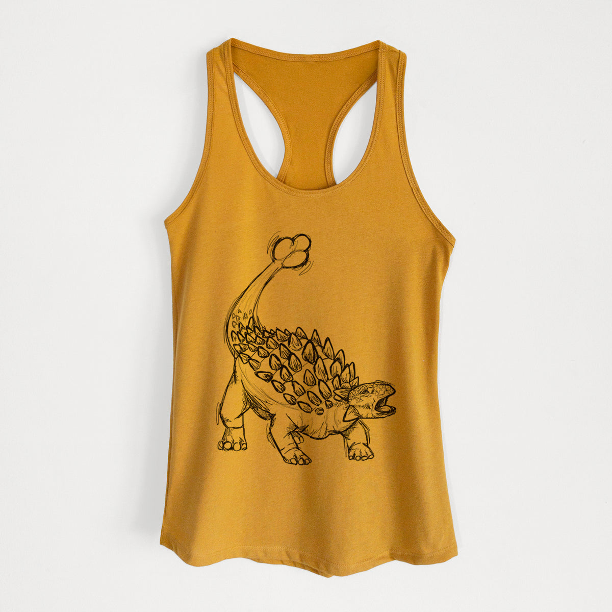 Gold women's racerback tank top laid flat, printed with a black ink illustration of an Ankylosaurus with its club tail raised.