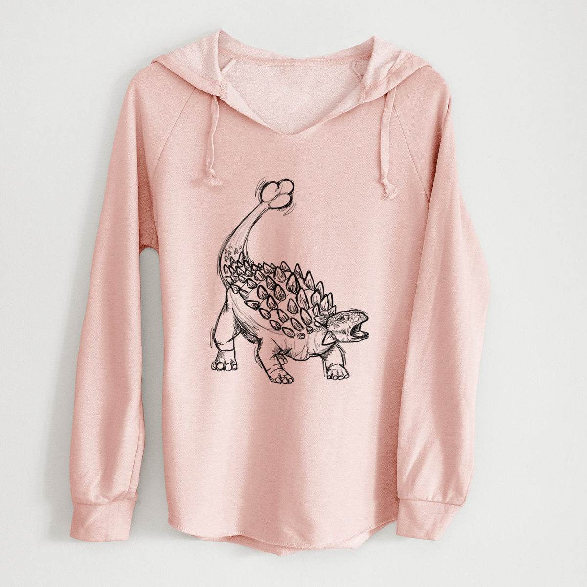 Blush pink women's Cali Wave hooded sweatshirt laid flat, printed with a black ink illustration of an Ankylosaurus with its club tail raised.