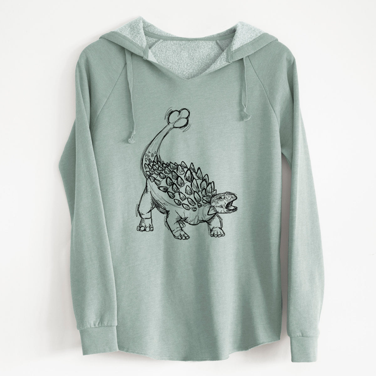 Sage green women's Cali Wave hooded sweatshirt laid flat, printed with a black ink illustration of an Ankylosaurus with its club tail raised.