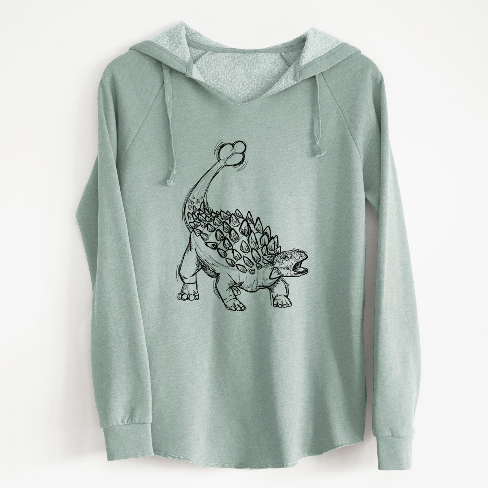 Sage green women's Cali Wave hooded sweatshirt laid flat, printed with a black ink illustration of an Ankylosaurus with its club tail raised.
