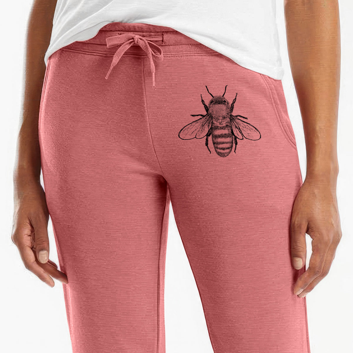 Front of dusty rose Cali Wave sweatpants, printed with a detailed black ink illustration of a honey bee with its wings spread, seen from above on the leg.