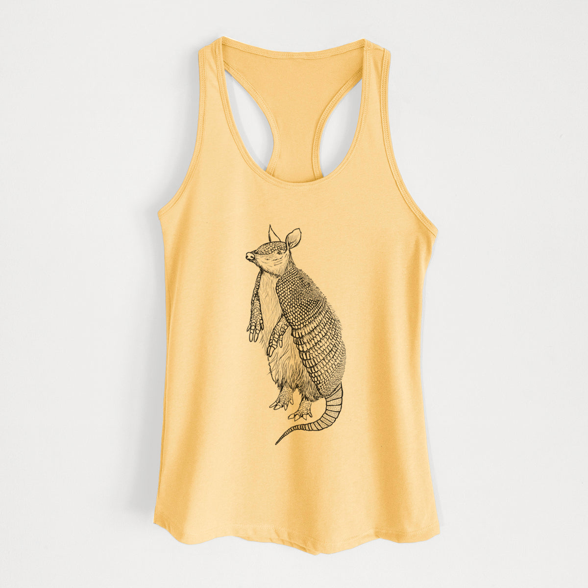 Banana cream women's racerback tank top laid flat, printed with a black ink illustration of a nine-banded armadillo standing upright.