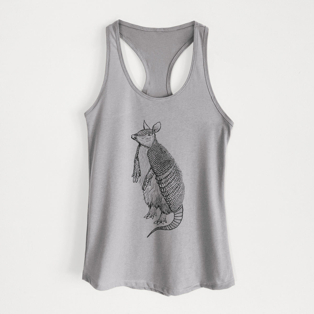 Heather grey women's racerback tank top laid flat, printed with a black ink illustration of a nine-banded armadillo standing upright.