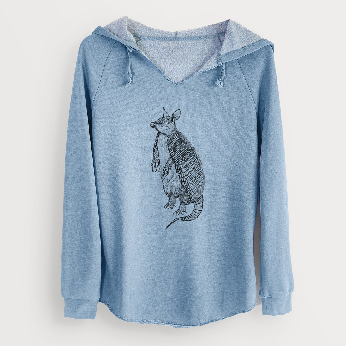 Misty blue women's Cali Wave hooded sweatshirt laid flat, printed with a black ink illustration of a nine-banded armadillo standing upright.