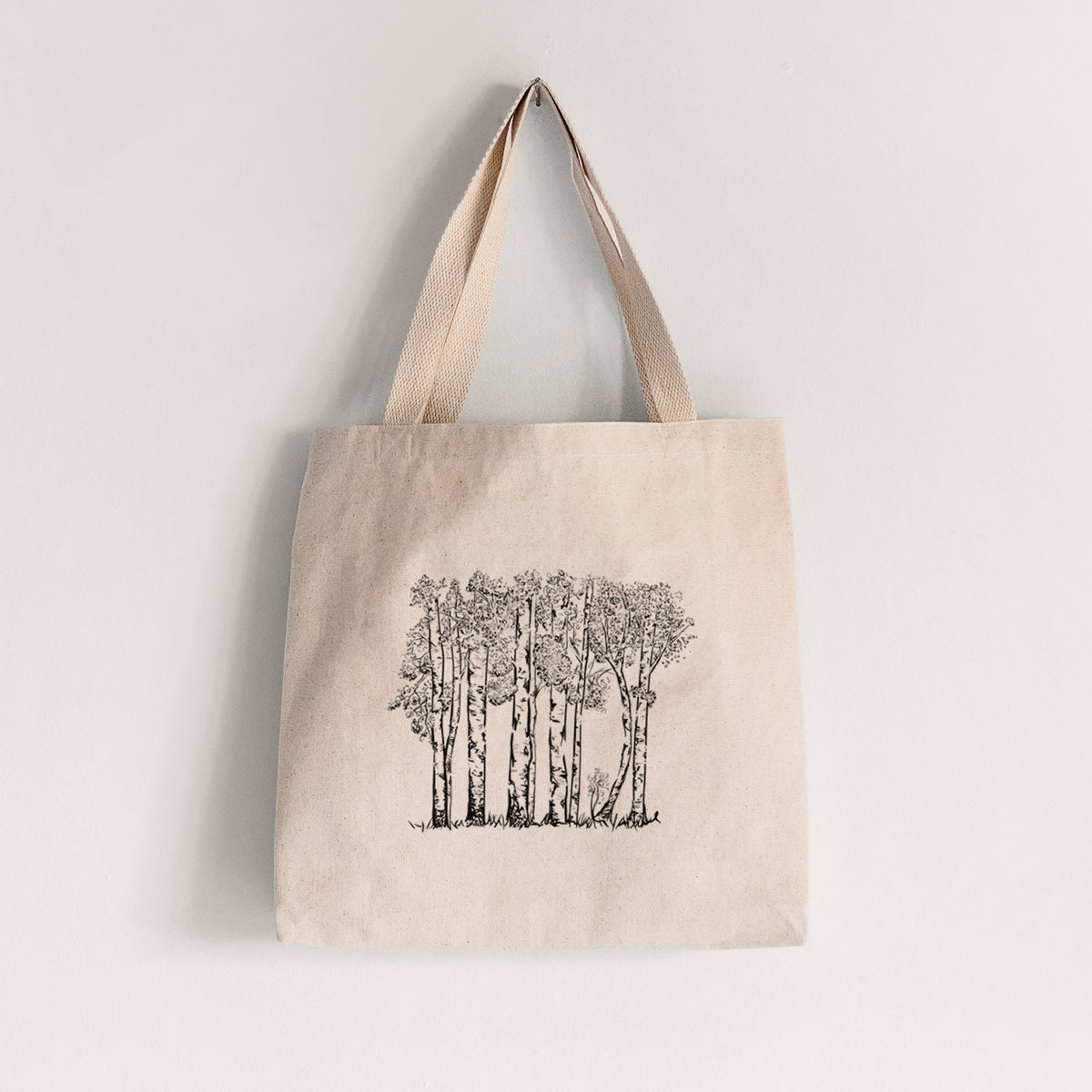 Natural canvas tote bag printed with a black ink illustration of a grove of aspen trees.