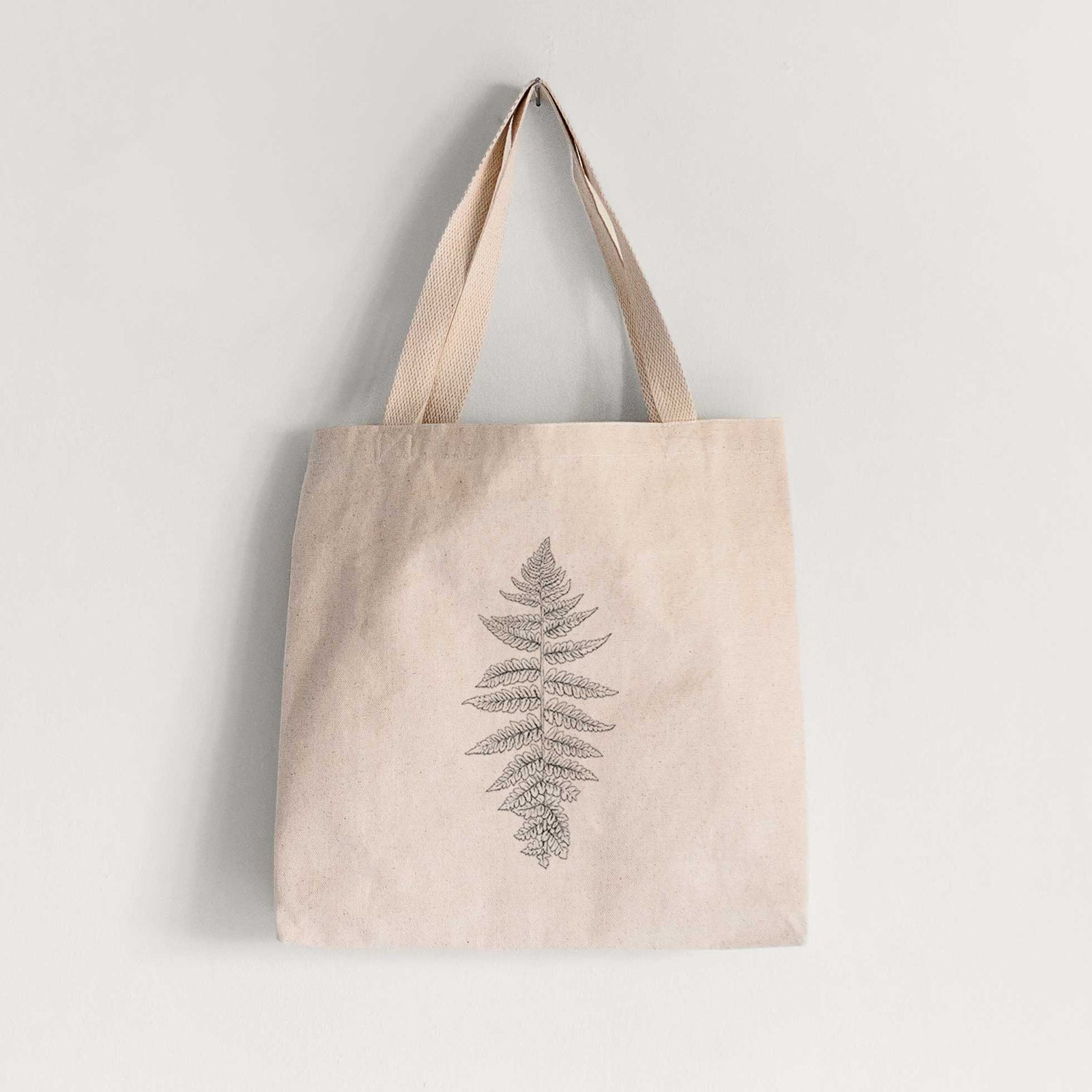Natural canvas tote bag printed with a black ink illustration of a lady fern frond.