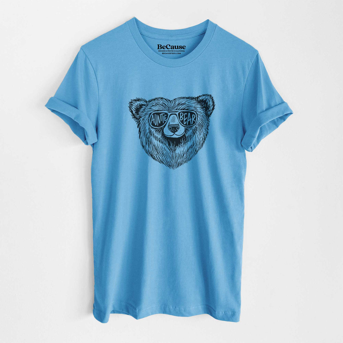 Ocean blue lightweight cotton t-shirt laid flat, printed with a black ink bear's face wearing sunglasses that read Auntie Bear.