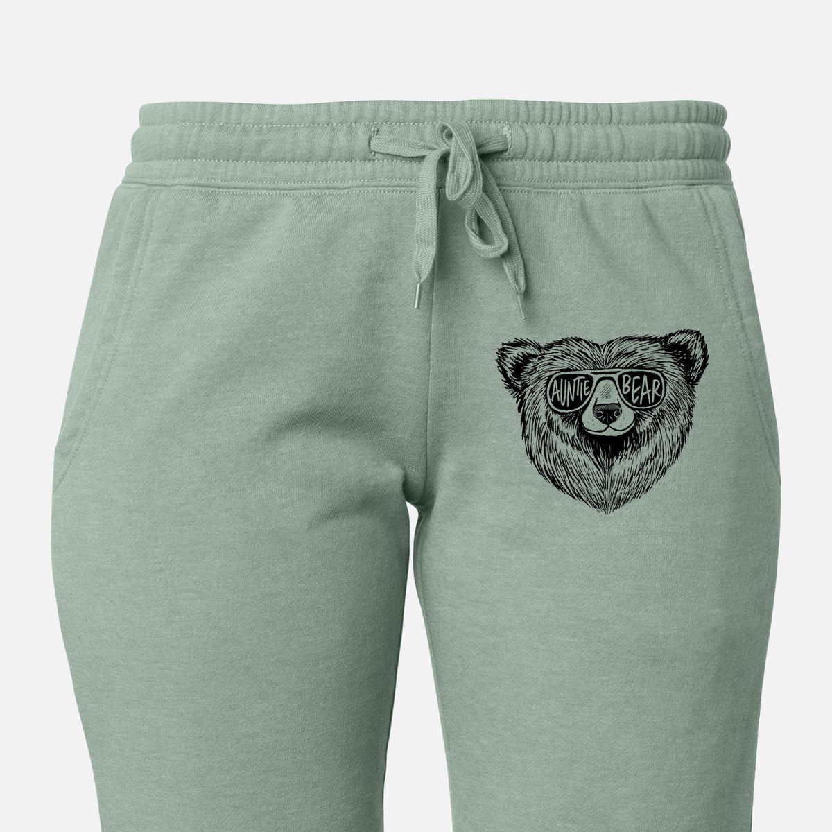 Front of sage green Cali Wave sweatpants, printed with a black ink bear's face wearing sunglasses that read Auntie Bear on the leg.