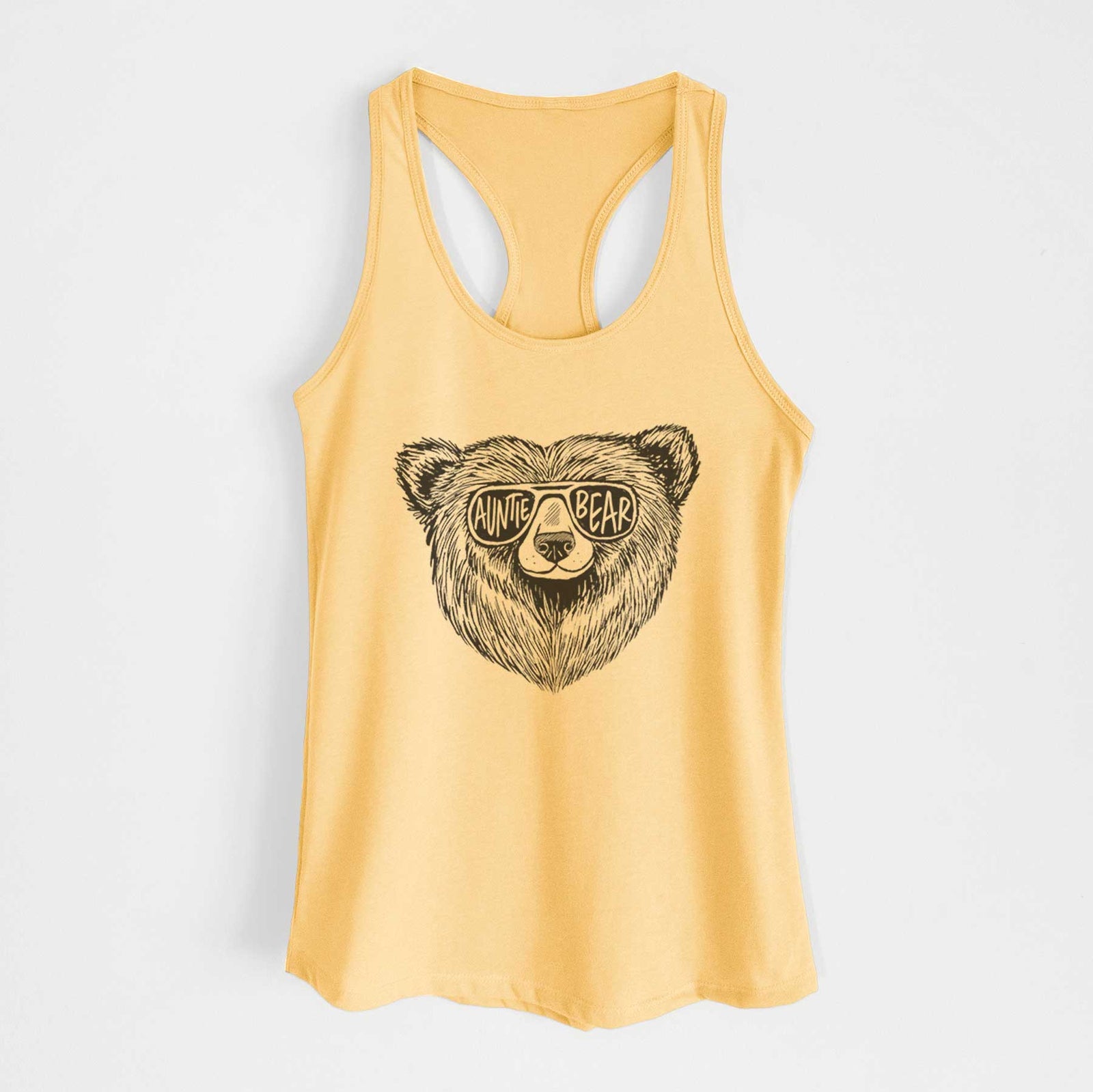 Banana cream women's racerback tank top laid flat, printed with a black ink bear's face wearing sunglasses that read Auntie Bear.