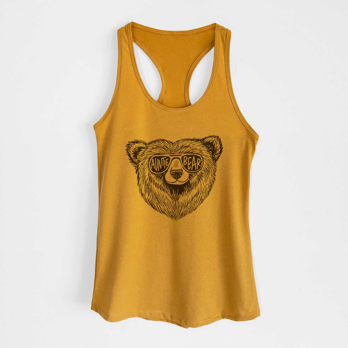 Gold women's racerback tank top laid flat, printed with a black ink bear's face wearing sunglasses that read Auntie Bear.