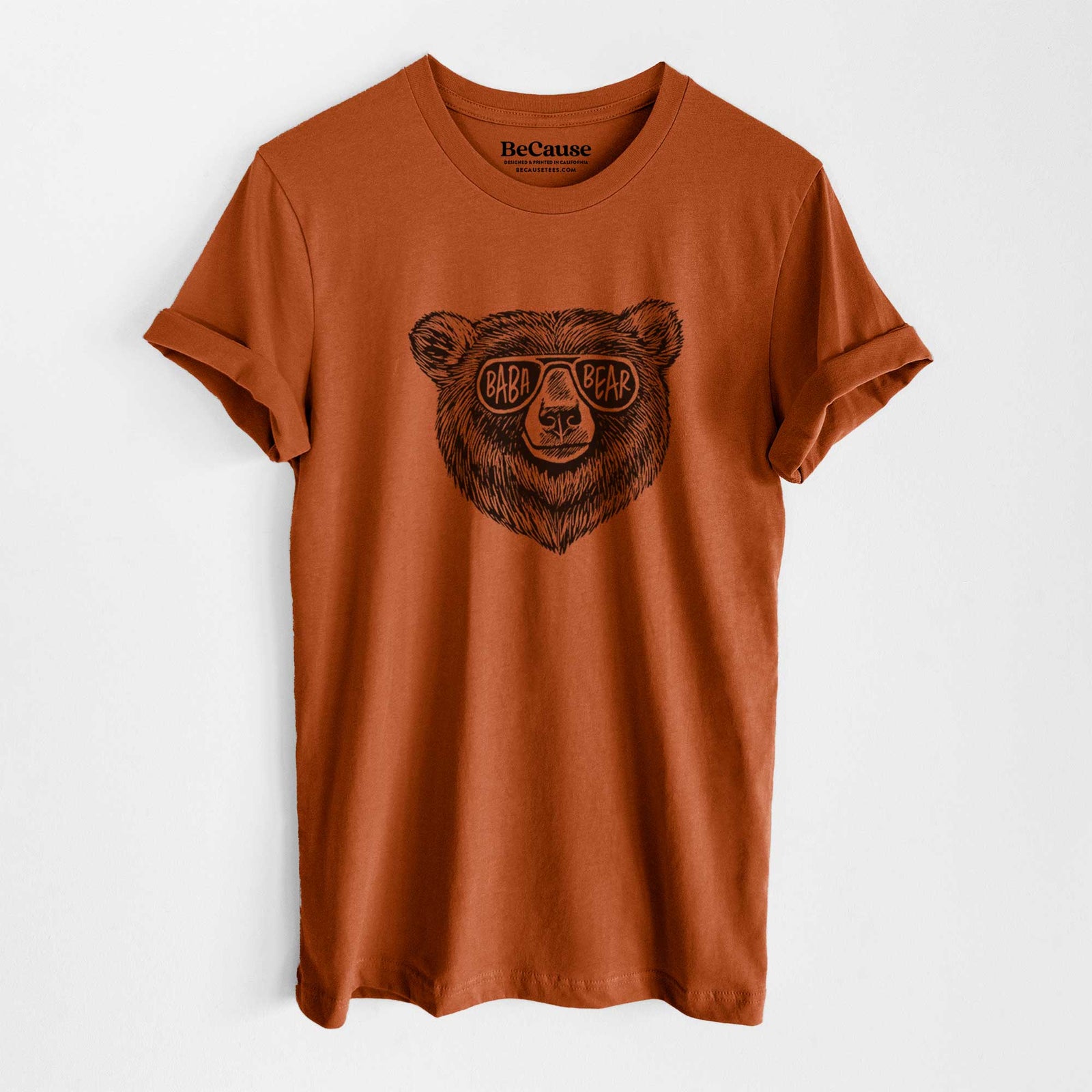 Autumn lightweight cotton t-shirt laid flat, printed with a black ink bear's face wearing sunglasses that read Baba Bear.