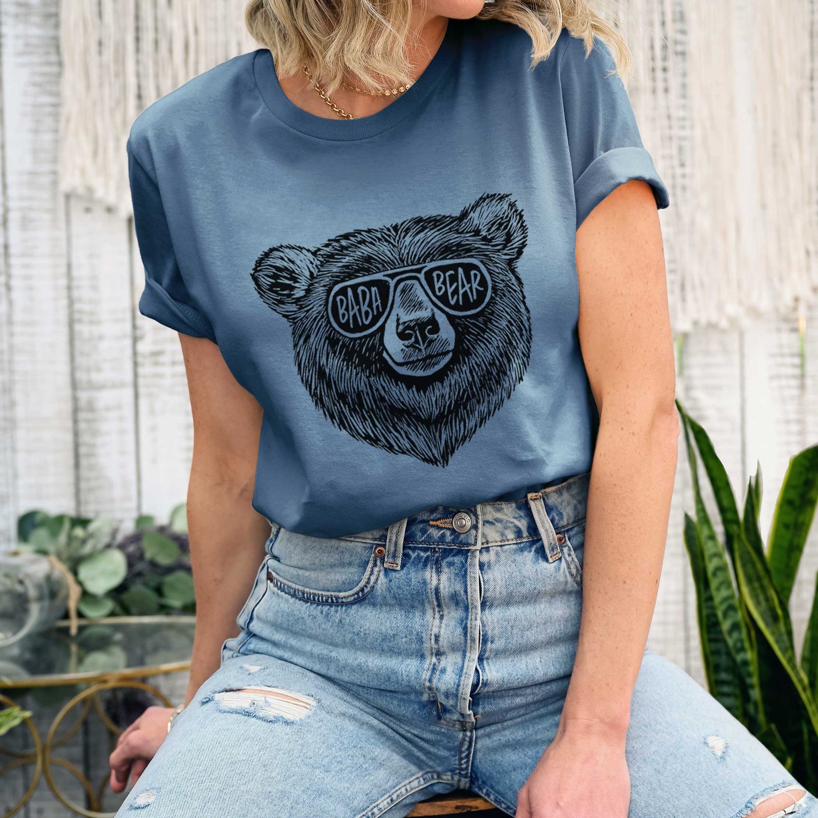 Autumn lightweight cotton t-shirt laid flat, printed with a black ink bear's face wearing sunglasses that read Baba Bear.