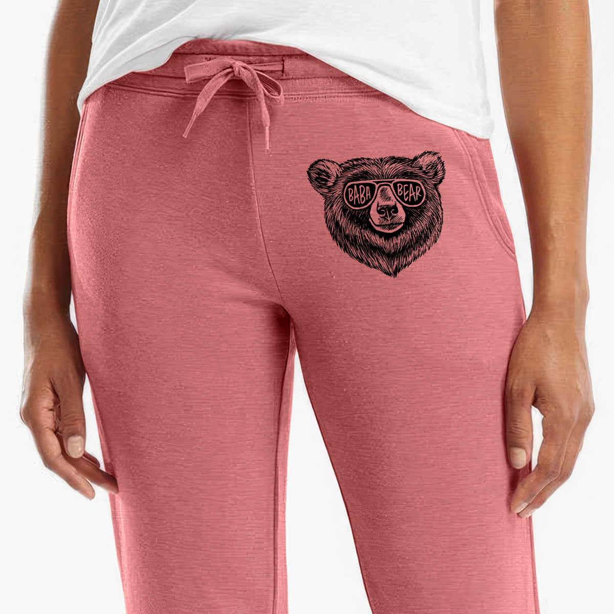 Front of dusty rose Cali Wave sweatpants, printed with a black ink bear's face wearing sunglasses that read Baba Bear on the leg.