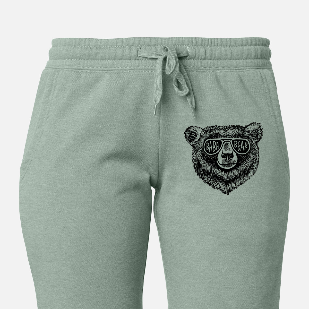 Front of sage green Cali Wave sweatpants, printed with a black ink bear's face wearing sunglasses that read Baba Bear on the leg.