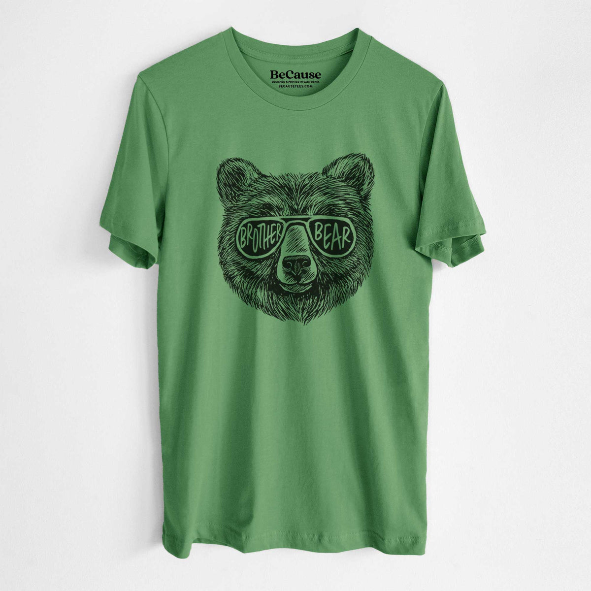 Leaf green lightweight cotton t-shirt laid flat, printed with a black ink bear's face wearing sunglasses that read Brother Bear.