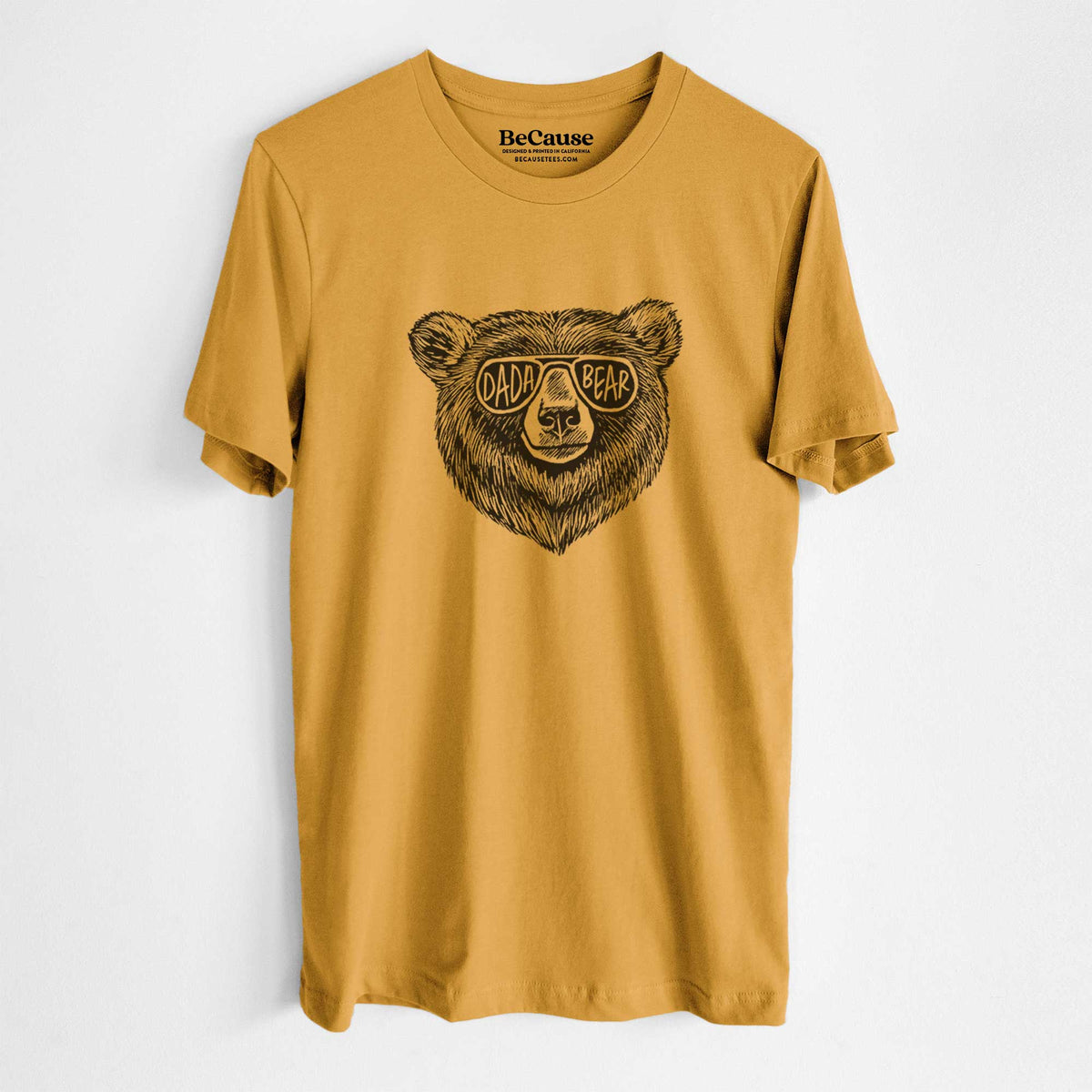 Mustard yellow lightweight cotton t-shirt laid flat, printed with a black ink bear's face wearing sunglasses that read Dada Bear.