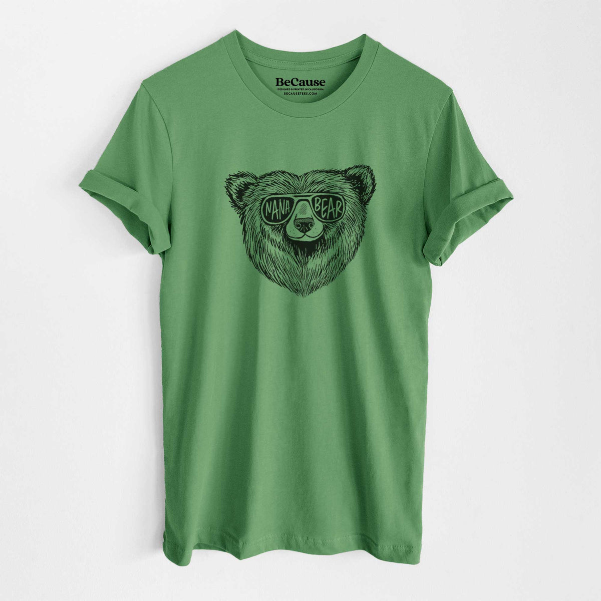 Leaf green lightweight cotton t-shirt laid flat, printed with a black ink bear's face wearing sunglasses that read Nana Bear.