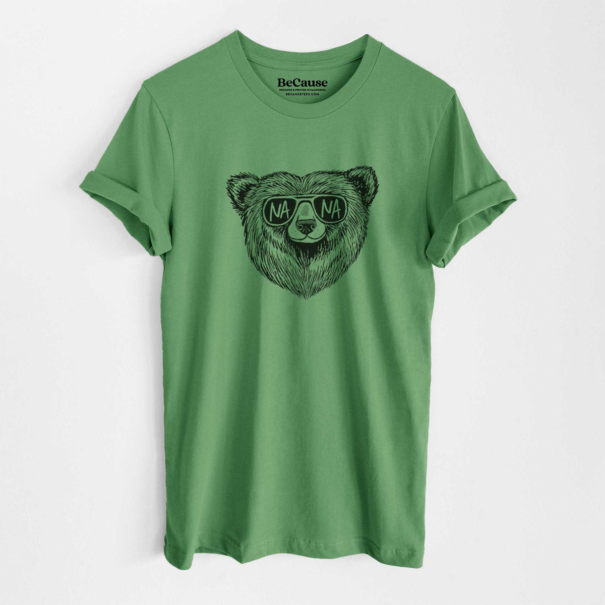 Leaf green lightweight cotton t-shirt laid flat, printed with a black ink bear's face wearing sunglasses that read Nana.